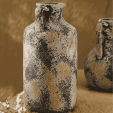 Two rustic ceramic vases with a textured surface on a beige background