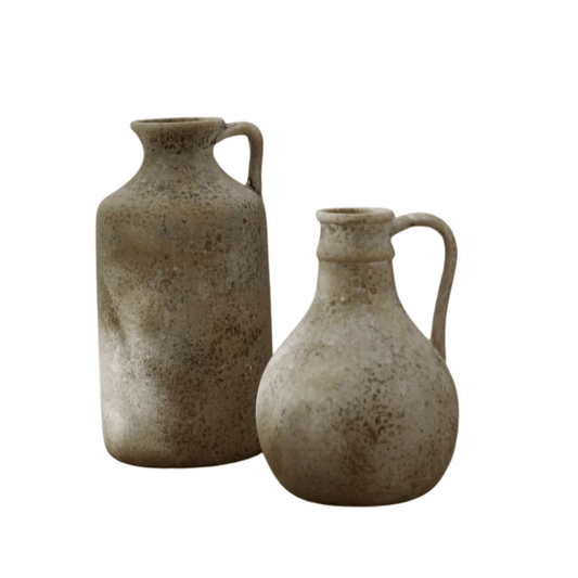Two ceramic jugs with handles on a white background
