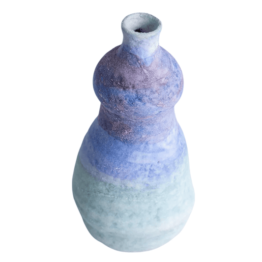 Ceramic vase with a textured blue and gray design on a white background