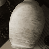 Textured ceramic vase on a dark surface