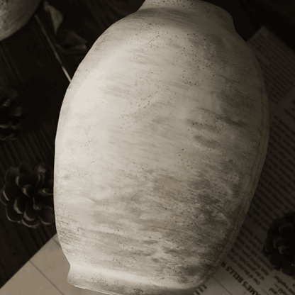 Textured ceramic vase on a dark surface