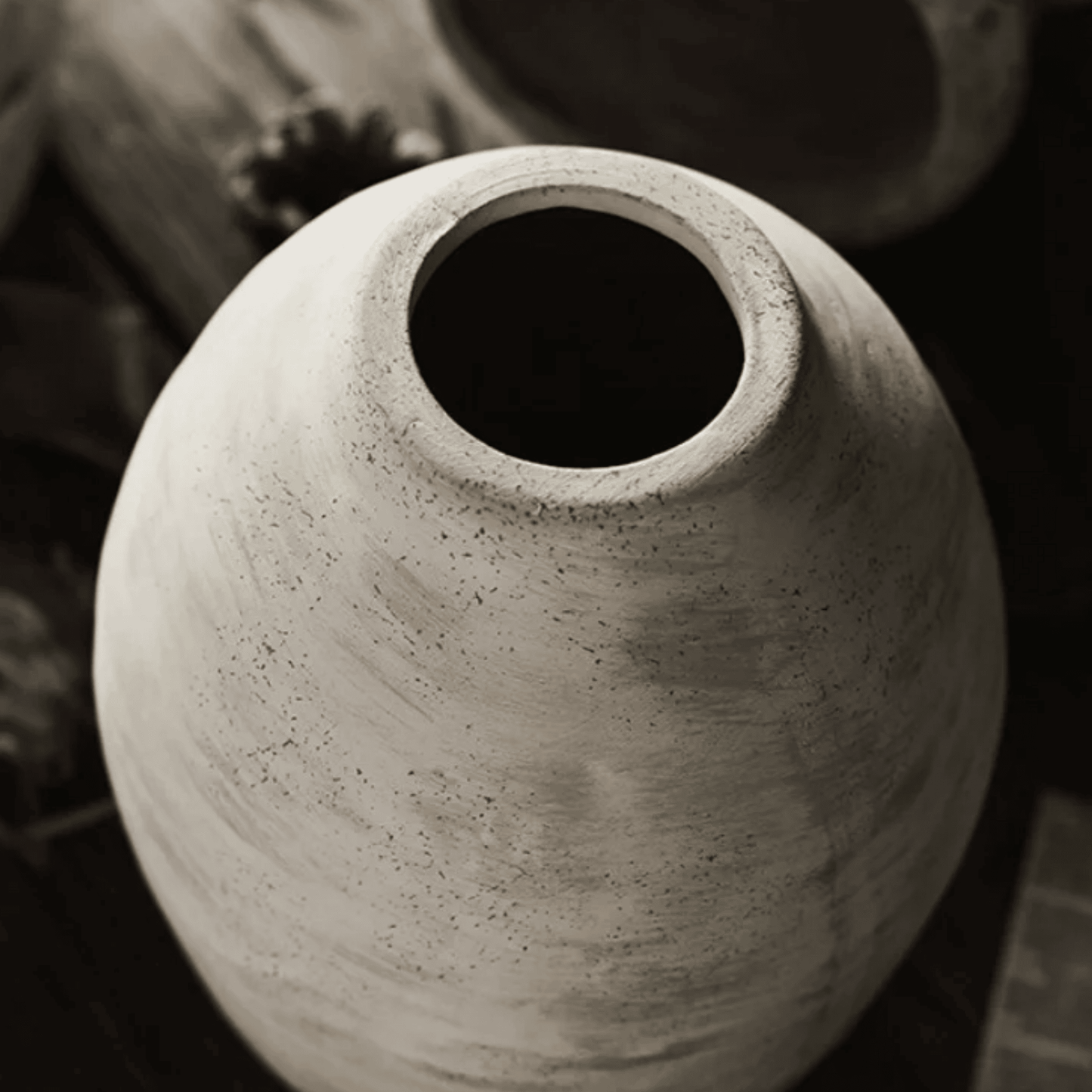 Close-up of a textured ceramic vase with a blurred background