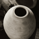 Close-up of a textured ceramic vase with a blurred background