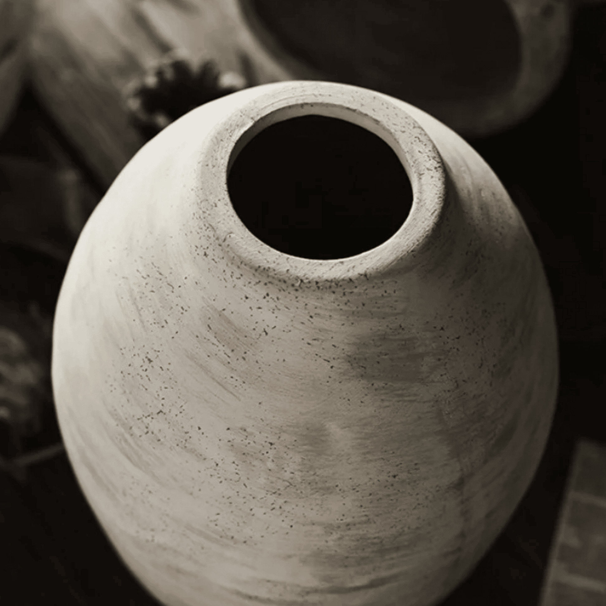 Close-up of a textured ceramic vase with a blurred background