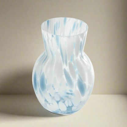Glass vase with blue and white swirl pattern on a white background