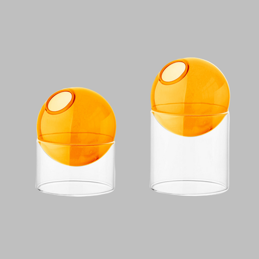 Two orange and clear containers on a white background