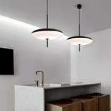Modern kitchen with pendant lights and a white island.