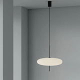 Modern pendant light hanging against a gray wall