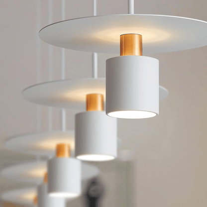 Modern pendant light fixture with white and gold components on a neutral background