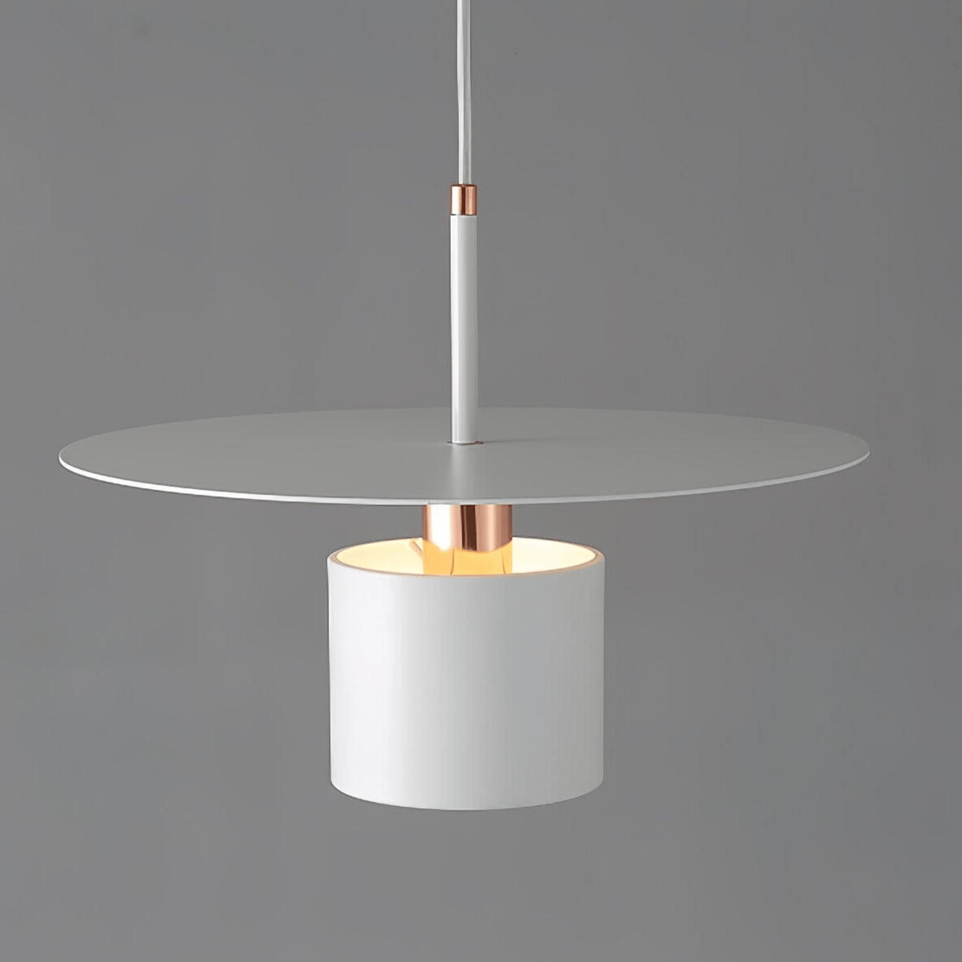 Modern pendant light with white glass shade and copper accents on a gray background