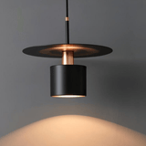 Modern pendant light with black and copper design on a gray background