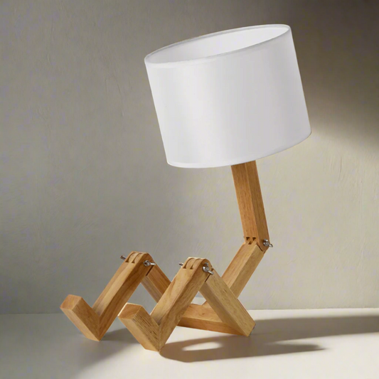 Table lamp with wooden base and white shade on a white background