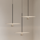 Modern pendant lights hanging against a neutral background