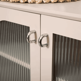 Close-up of a white cabinet with silver knobs on a white background