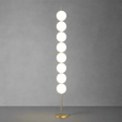 Modern floor lamp with round glass shades on a beige background