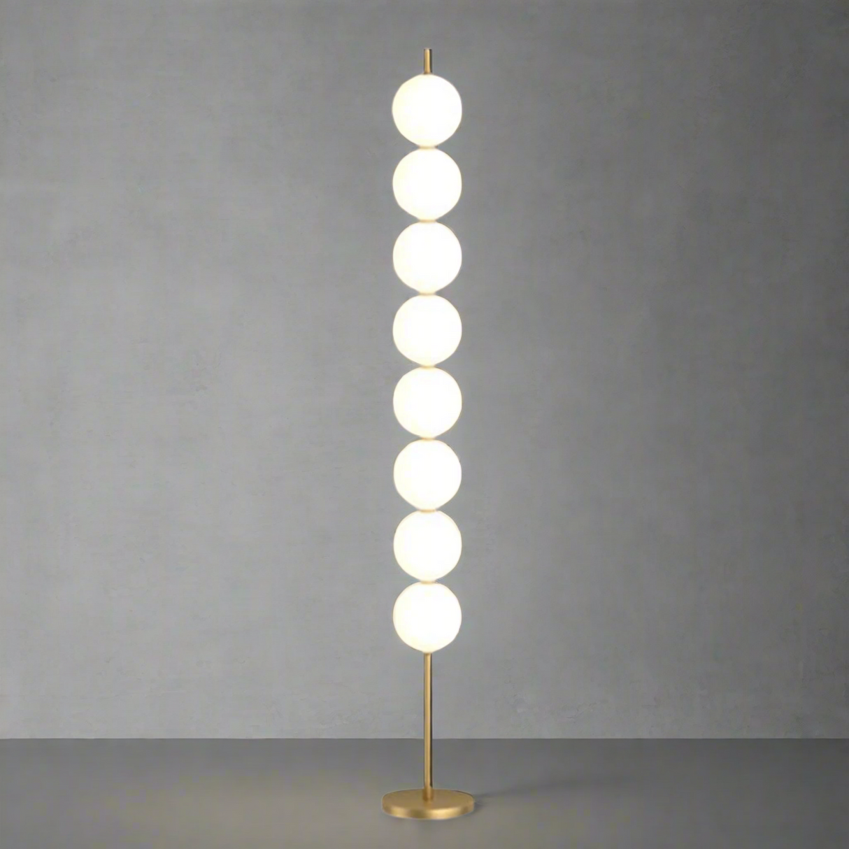 Modern floor lamp with round glass shades on a beige background