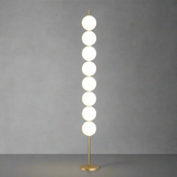 Modern floor lamp with round glass shades on a beige background