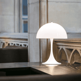 White table lamp on a wooden surface with a blurred background