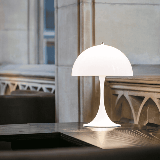White table lamp on a wooden surface with a blurred background