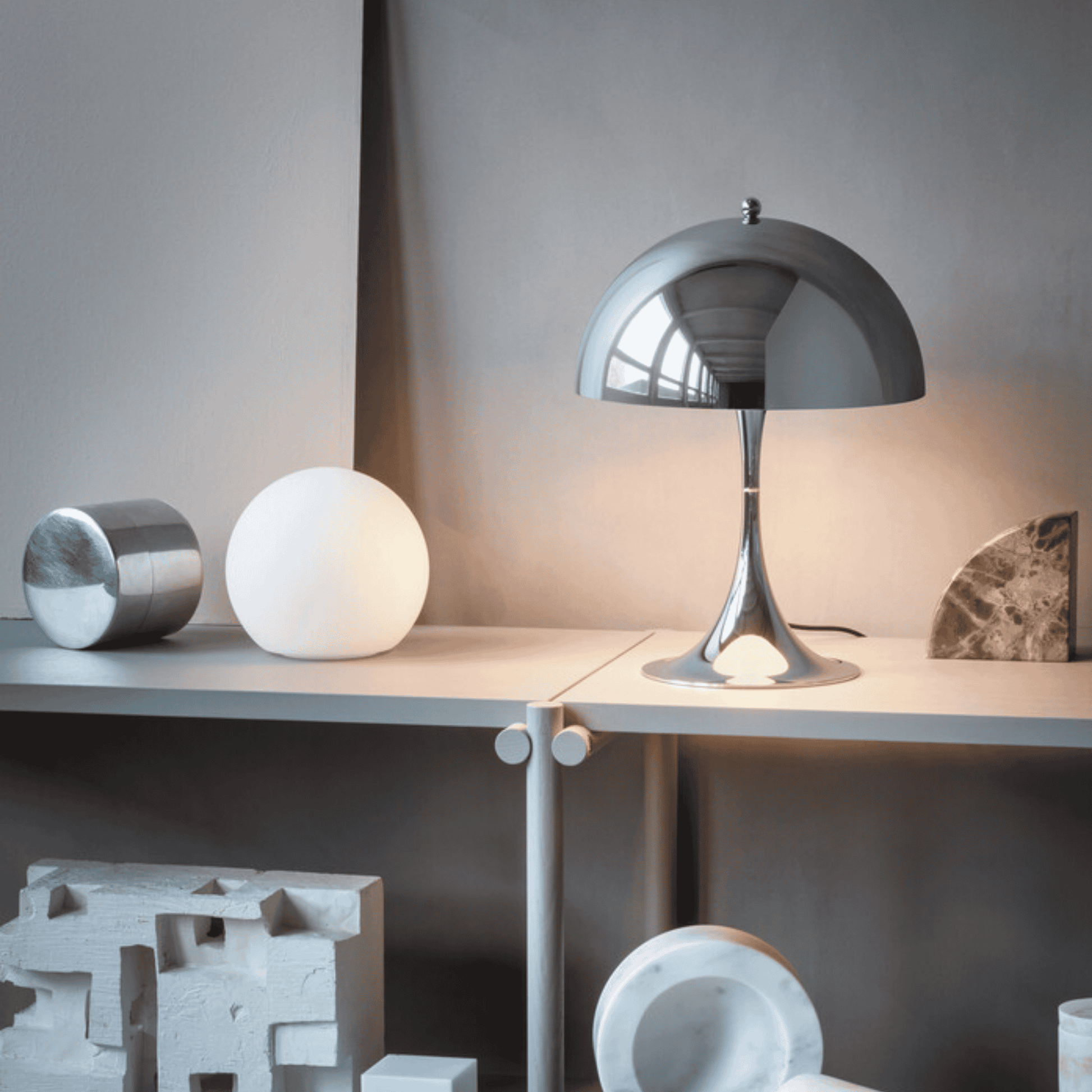 Modern table lamp on a surface with decorative items in a minimalistic setting