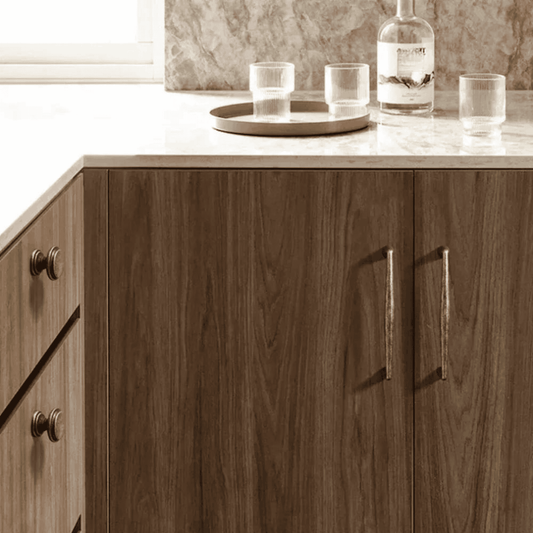 Wooden cabinet with marble countertop and glassware in a kitchen setting