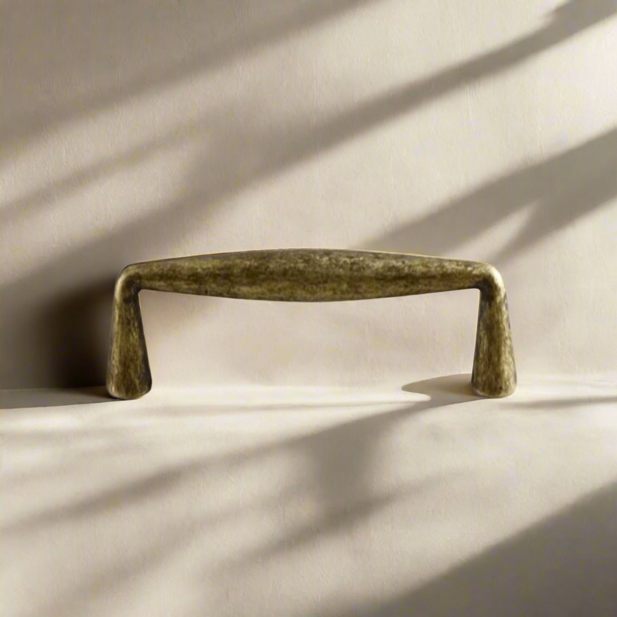 Bronze cabinet handle on a beige background