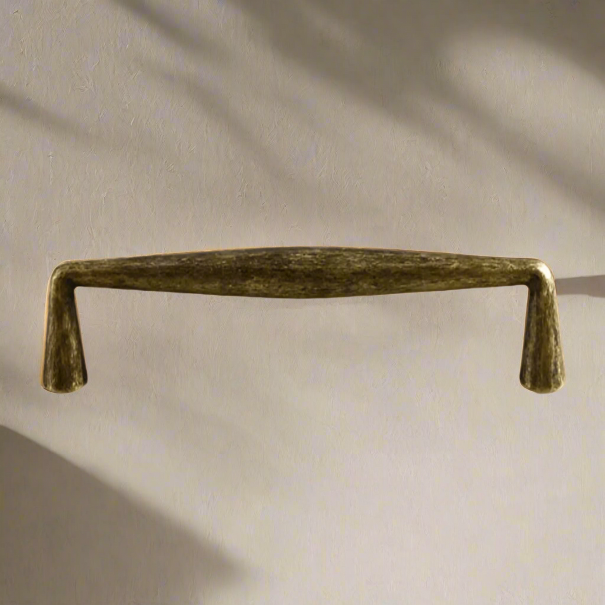 Bronze cabinet handle on a beige background
