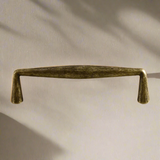 Bronze cabinet handle on a beige background