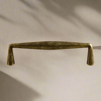 Bronze cabinet handle on a beige background