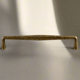 Bronze cabinet handle on a beige background