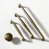 Set of bronze cabinet handles on a white background