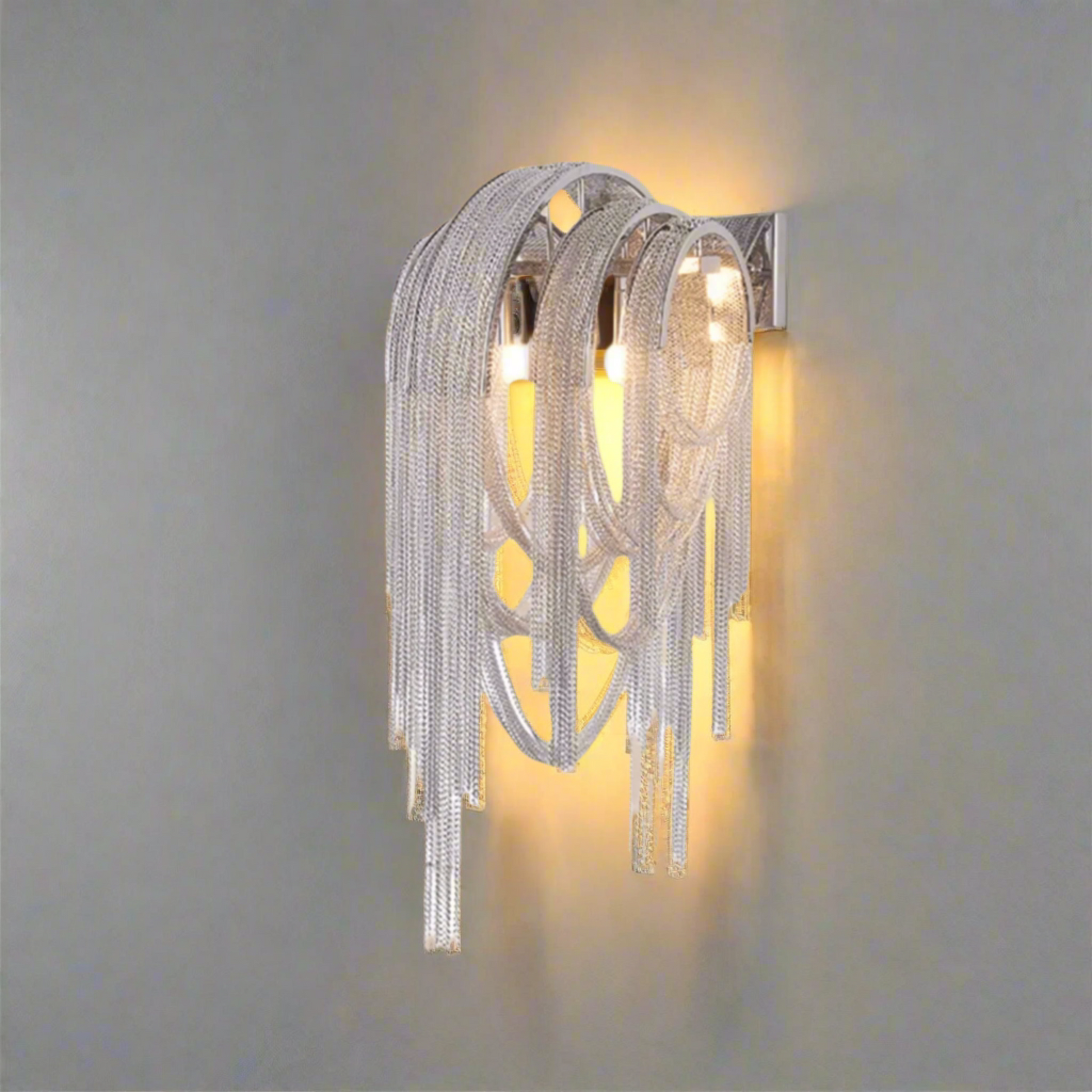 Decorative wall light fixture with chain-like design on a white background