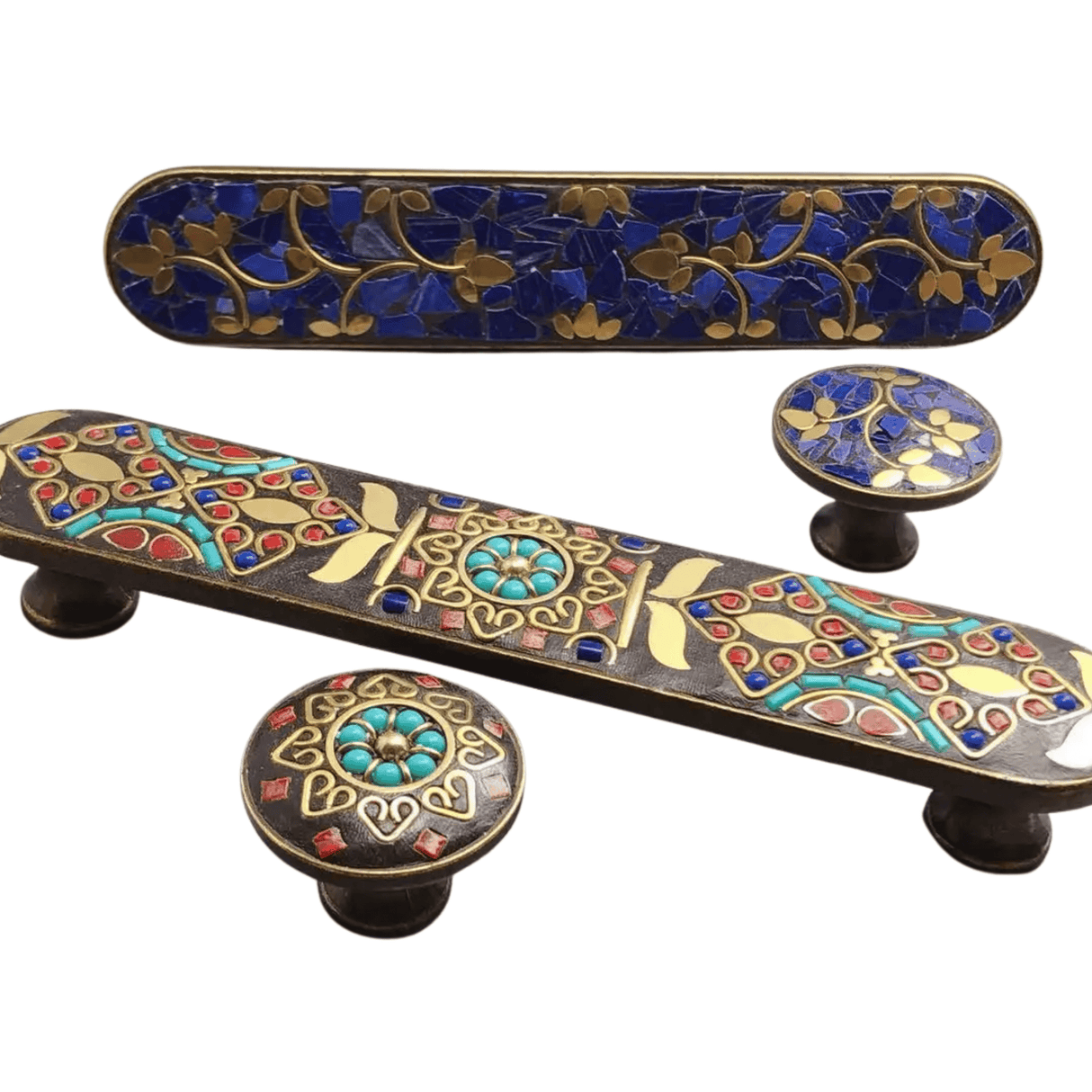 Decorative cabinet handles with intricate designs on a white background