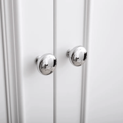 Close-up of a white cabinet with silver knobs on a white background