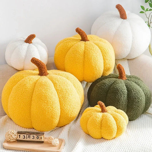 Set of colorful pumpkin-shaped cushions on a light background