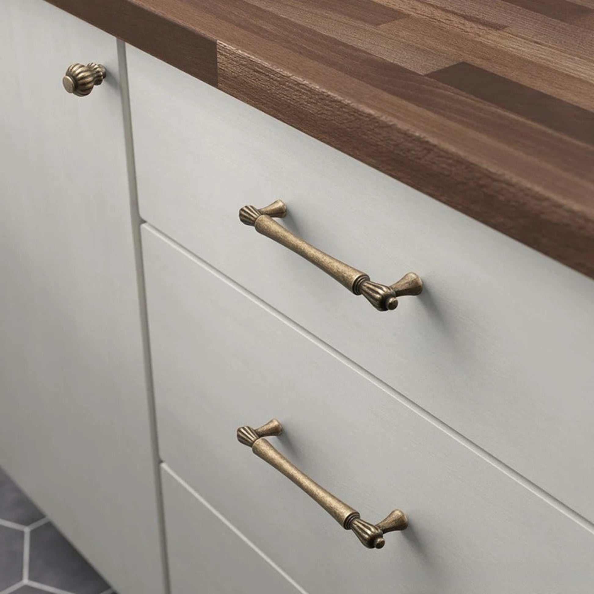 Cabinets with brass handles on a wooden countertop