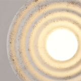 Close-up of a decorative ceiling light fixture with concentric circular design.