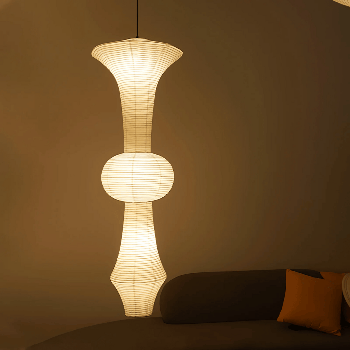 Modern pendant light fixture in a living room setting with a neutral background