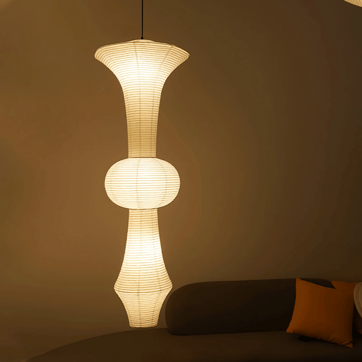 Modern pendant light fixture in a living room setting with a neutral background