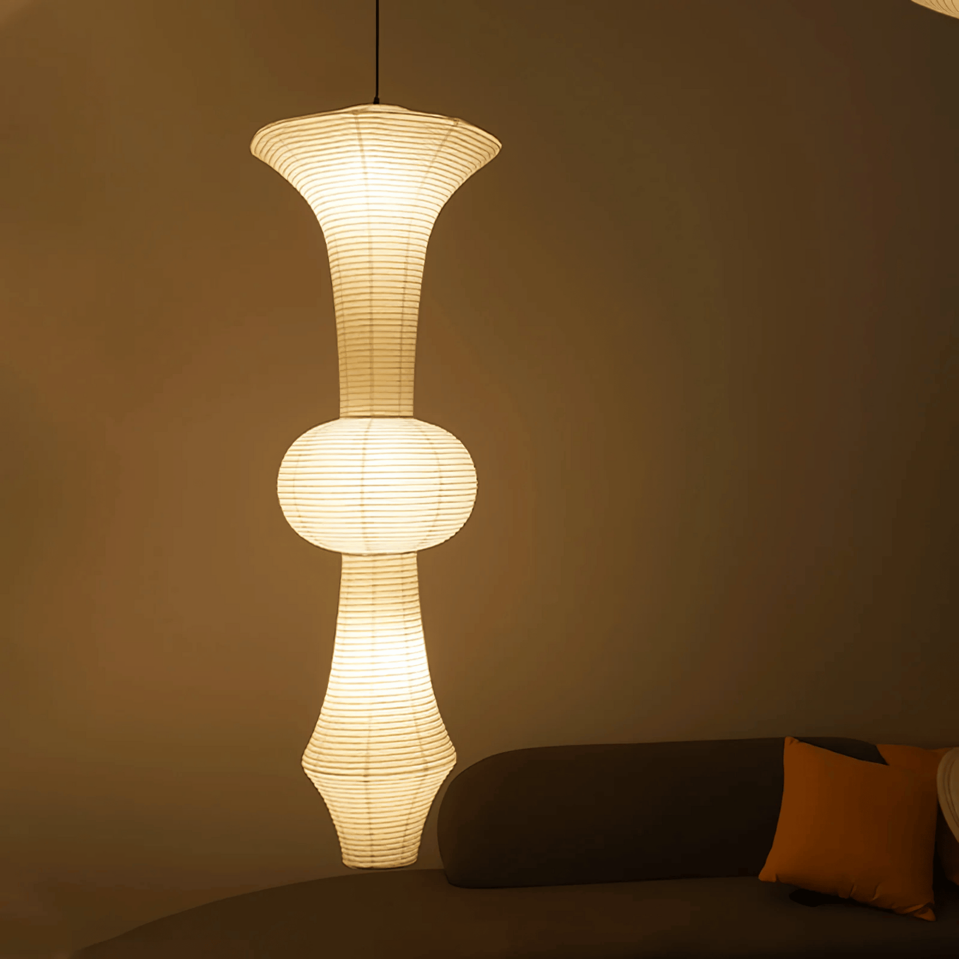 Modern pendant light fixture in a living room setting with a neutral background