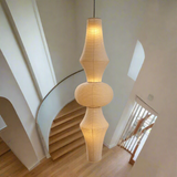 Beige pendant lamp with a ribbed design on a white background