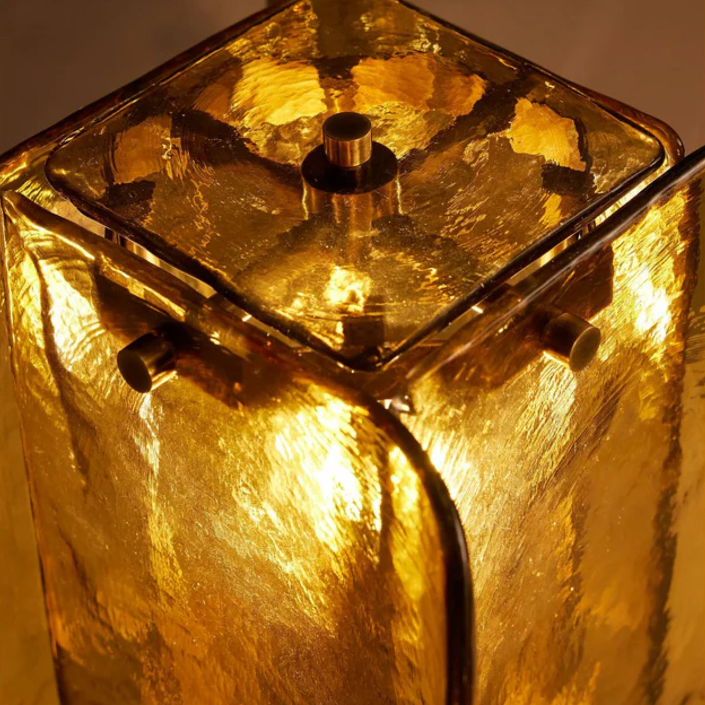 Top view of amber glass table lamp highlighting bulb, metal frame, and intricate craftsmanship