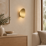 Alabaster chandelier – Wall lamp – lifestyle Installed on warm beige plaster wall in refined living room, physically small wall light with normal size furnishings.