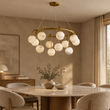 Marble ball light – 80cm Brass – lifestyle Installed above dining table in elegant warm beige dining room, ceiling connection visible, exact scale relative normal furniture.