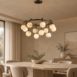 Marble ball light – 80cm Black – lifestyle Installed above dining table in elegant warm beige dining room, ceiling connection visible, exact scale relative normal furniture.