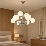 Chrome glass chandelier – 9 heads Chrome – lifestyle Installed in refined bedroom above warm wood furniture, 70cm diameter realistic scale, glowing softly.