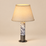 A short Spain Iron Base Cylindrical Marble LED E27 Table Lamp Parchment Lampshade Moden Living Room Bedroom Restaurant Office Desk Light — premium background photograph