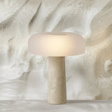 Beige table lamp with a textured base on a marble surface