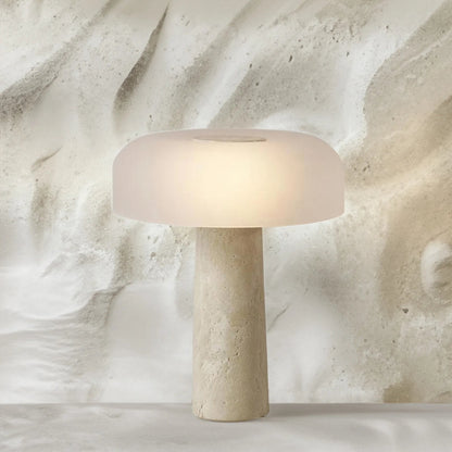 Beige table lamp with a textured base on a marble surface