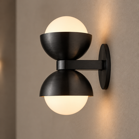 Black brass glass wall lamp close-up showing brushed metal and frosted glass